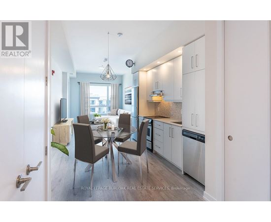 A modern kitchen with a dining table set for four.