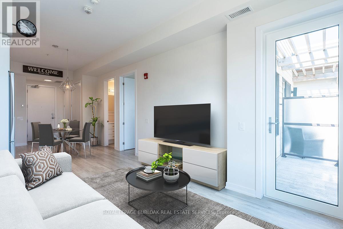 A living room with a white couch and a black television.