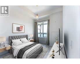A bedroom with a large bed and a painting on the wall.