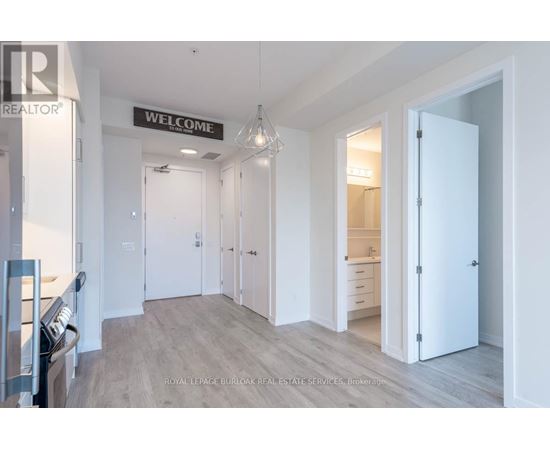 A spacious room with a "Welcome" sign on the wall.