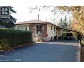 A house with a driveway and a car parked in front.