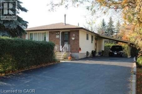 A house with a driveway and a car parked in front.