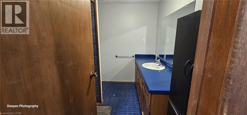 A bathroom with a blue counter top and a wooden door.