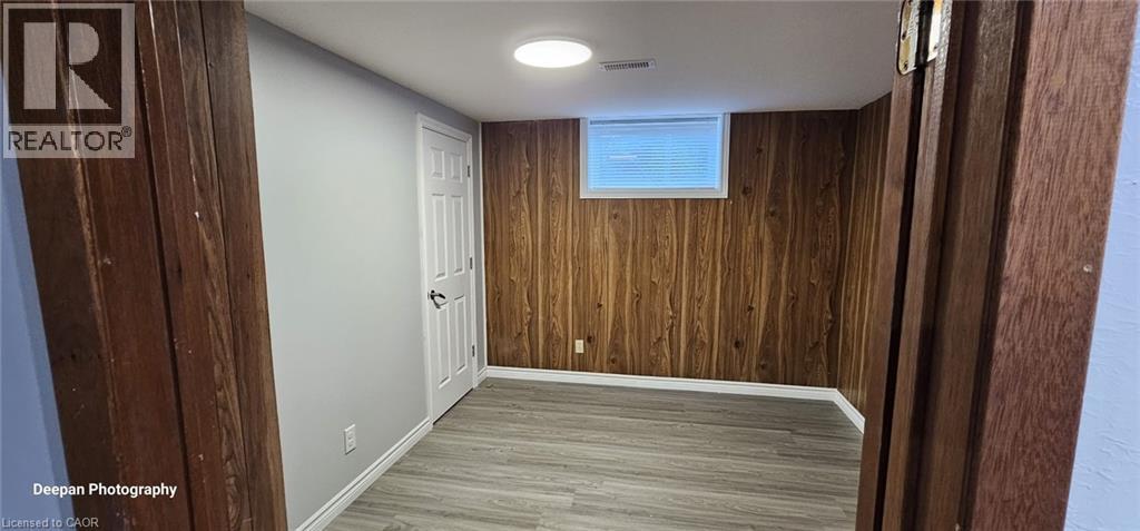 A room with wooden walls and a white door.