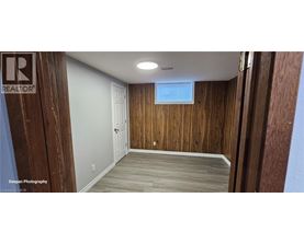 A room with wooden walls and a white door.