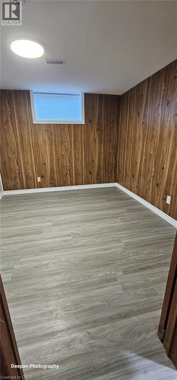 A room with wooden walls and a window.