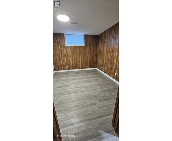 A room with wooden walls and a window.