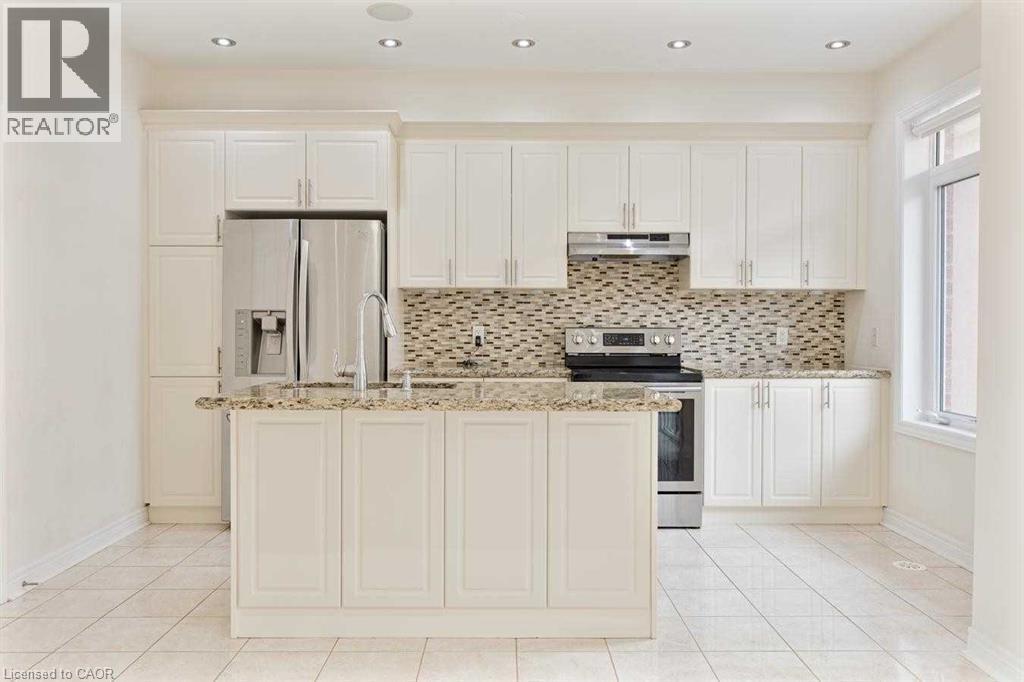 A kitchen with white cabinets and a granite countertop.