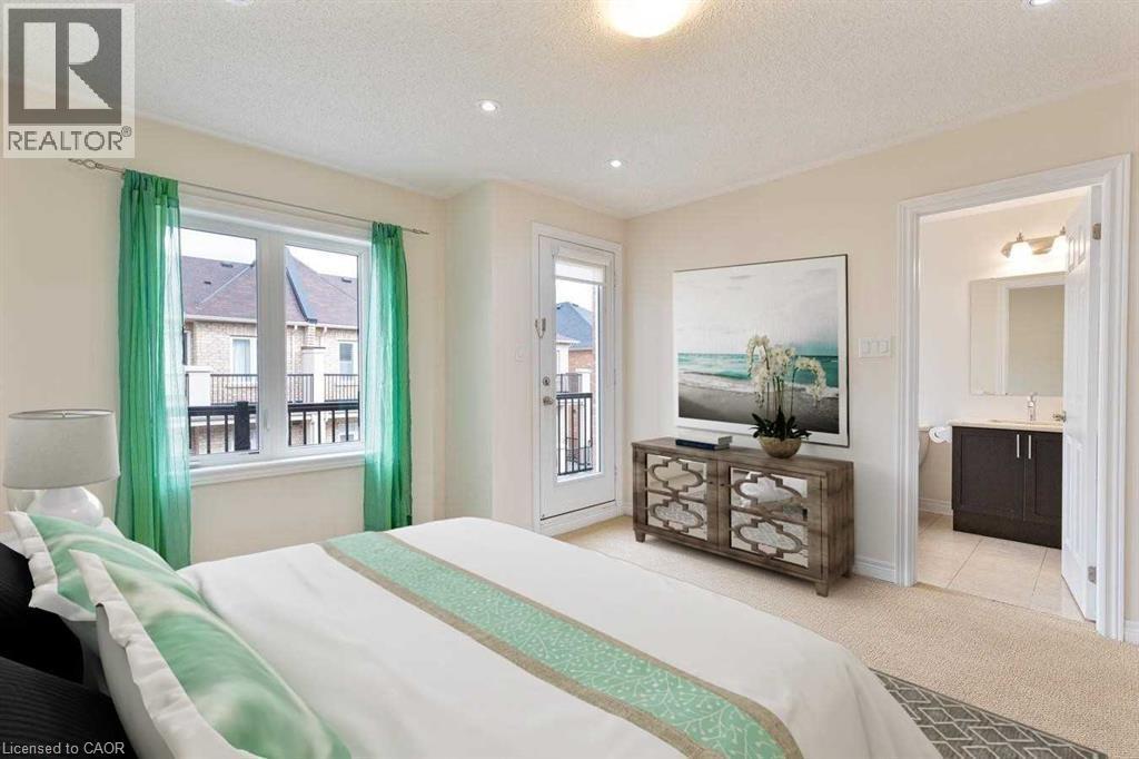 A bedroom with a large bed and a balcony with a view of buildings outside.