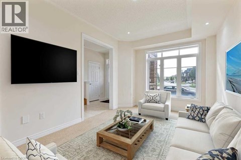 A living room with a white couch and a wooden coffee table.