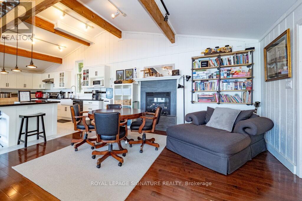A living room with a grey couch and a fireplace.