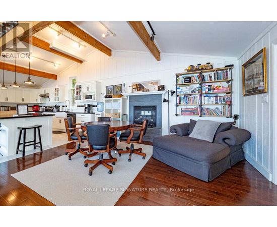 A living room with a grey couch and a fireplace.