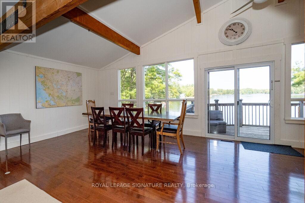 A dining room with a wooden table and chairs.