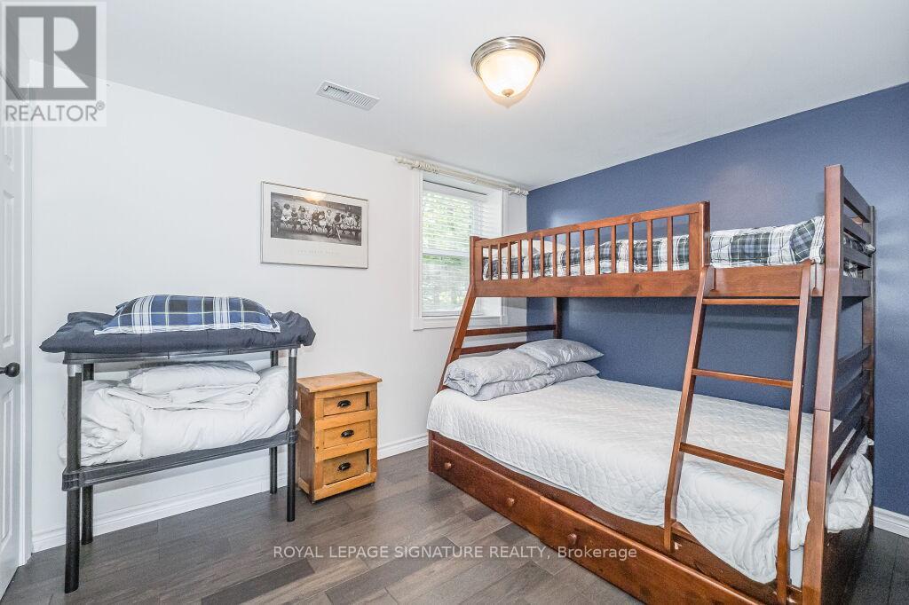 A bedroom with two beds and a dresser.