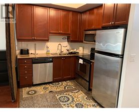 A kitchen with wooden cabinets and stainless steel appliances.