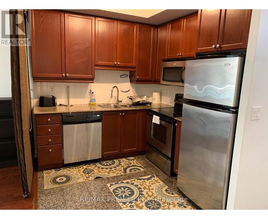 A kitchen with wooden cabinets and stainless steel appliances.