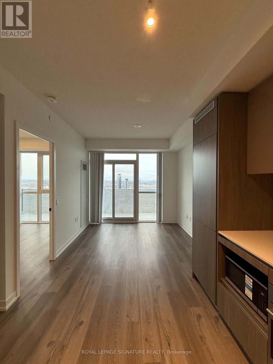 A spacious kitchen with wooden floors and modern appliances.