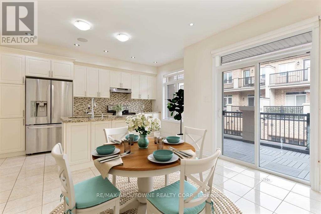 A dining room with a table set for four and a view of a balcony outside.