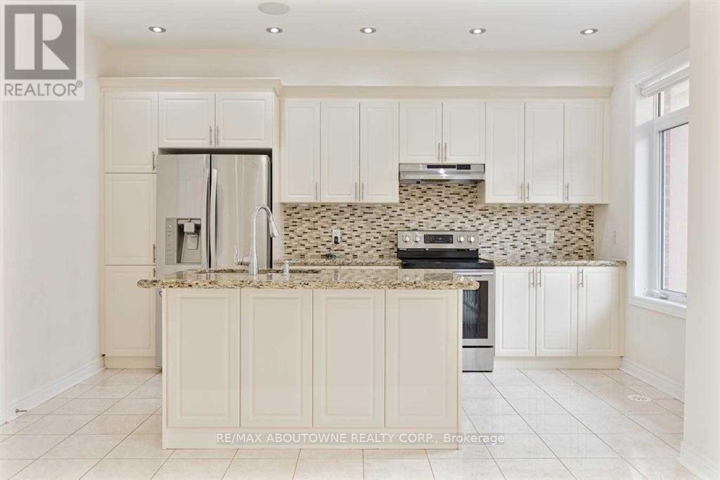 A kitchen with white cabinets and a granite countertop.