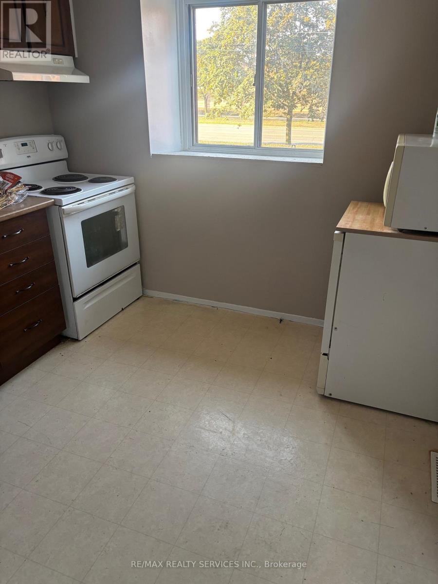 A small kitchen with a white stove and a white refrigerator.