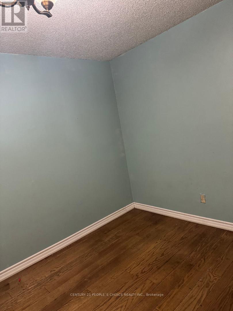 A room with wooden flooring and a light blue wall.