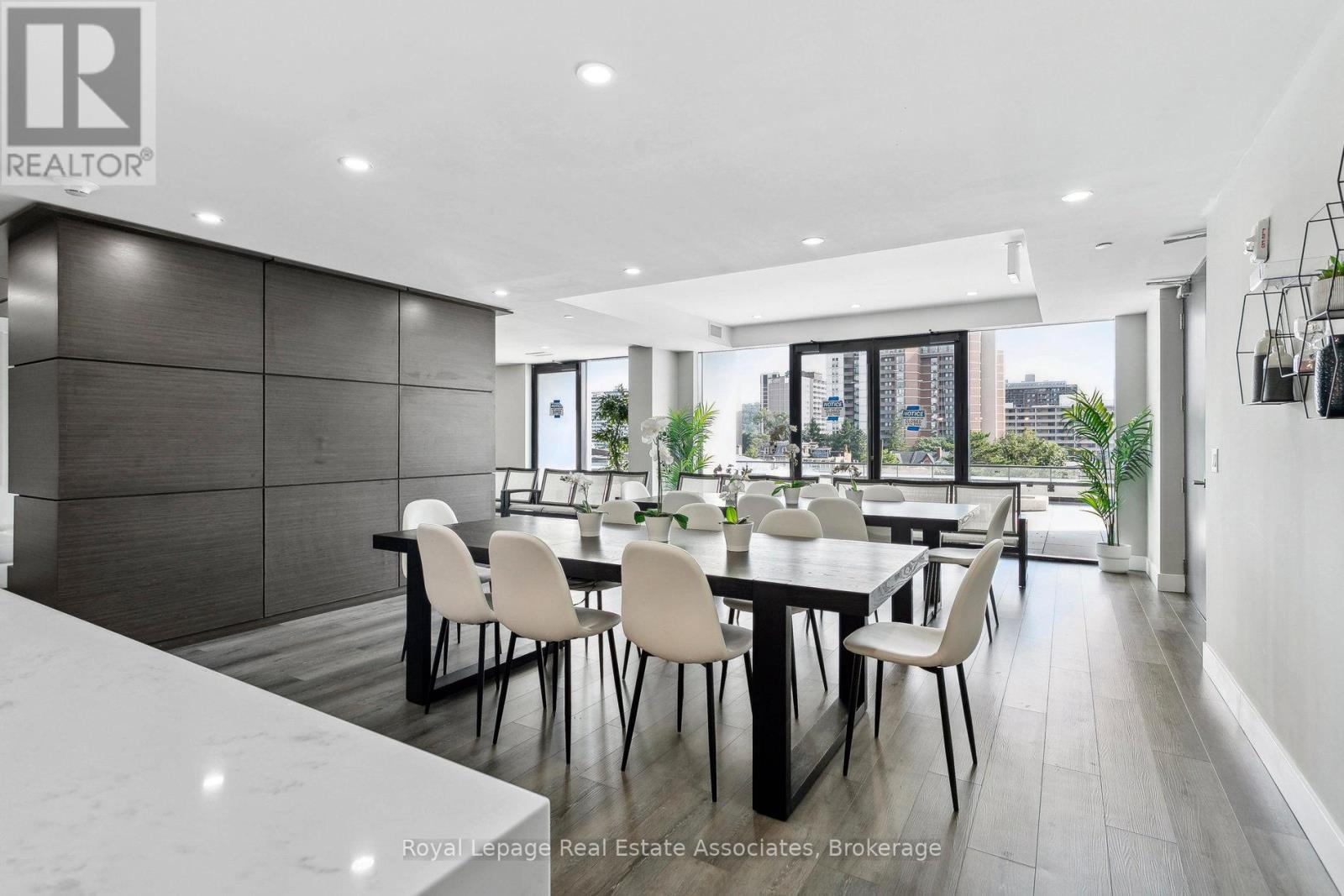 A modern dining room with a long table and chairs.