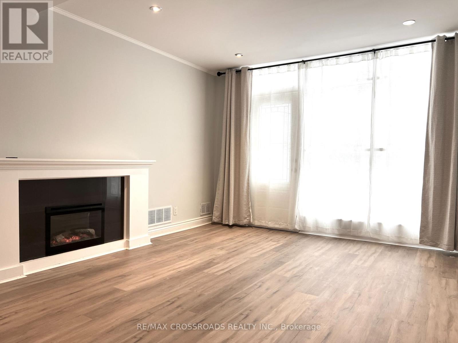 A living room with a fireplace and sliding glass doors.