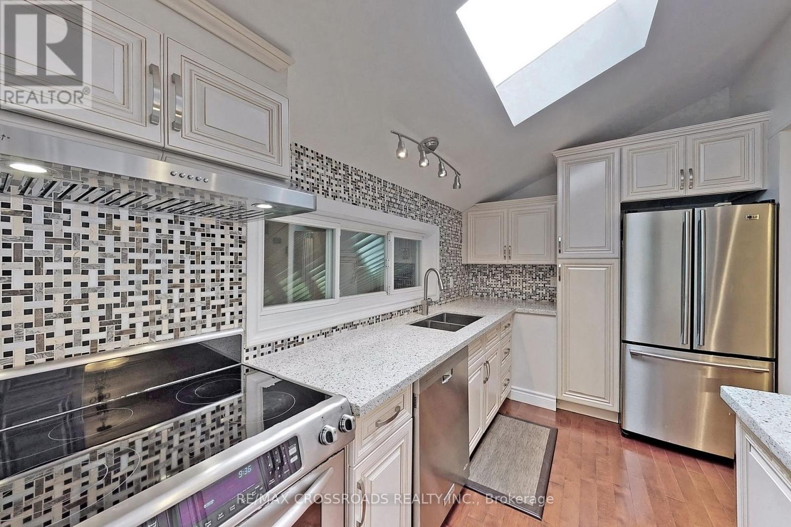 A kitchen with a stove top oven and a refrigerator.