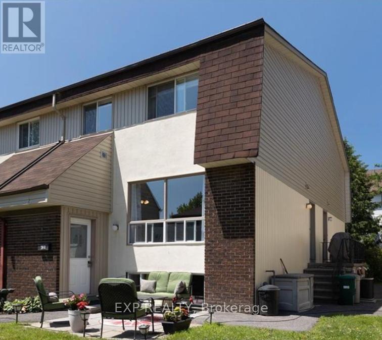A house with a brown roof and a white wall is for sale.