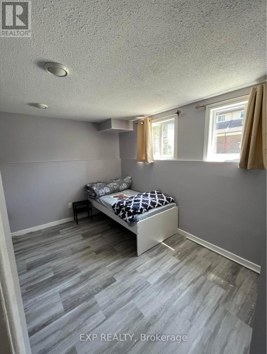 A bedroom with a bed and a window with curtains.