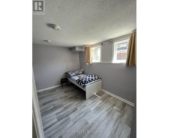 A bedroom with a bed and a window with curtains.