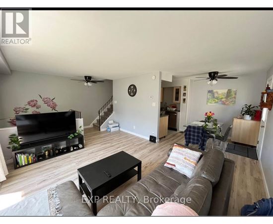 A living room with a brown couch and a flat screen TV.