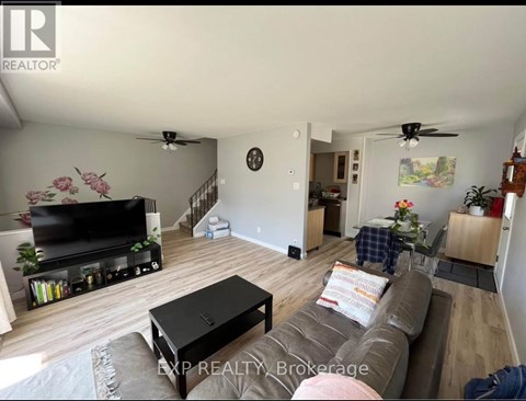 A living room with a brown couch and a flat screen TV.