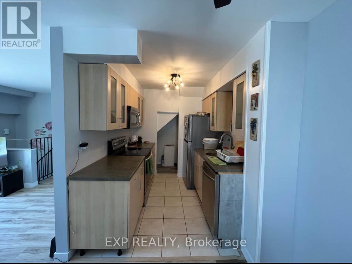 A kitchen with wooden cabinets and a refrigerator.