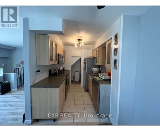 A kitchen with wooden cabinets and a refrigerator.