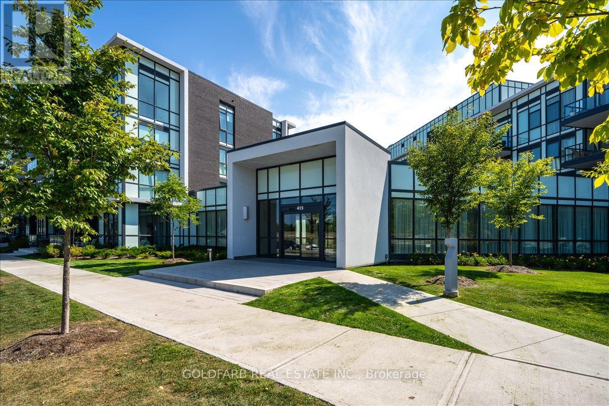 A modern building with a white entrance and glass windows.