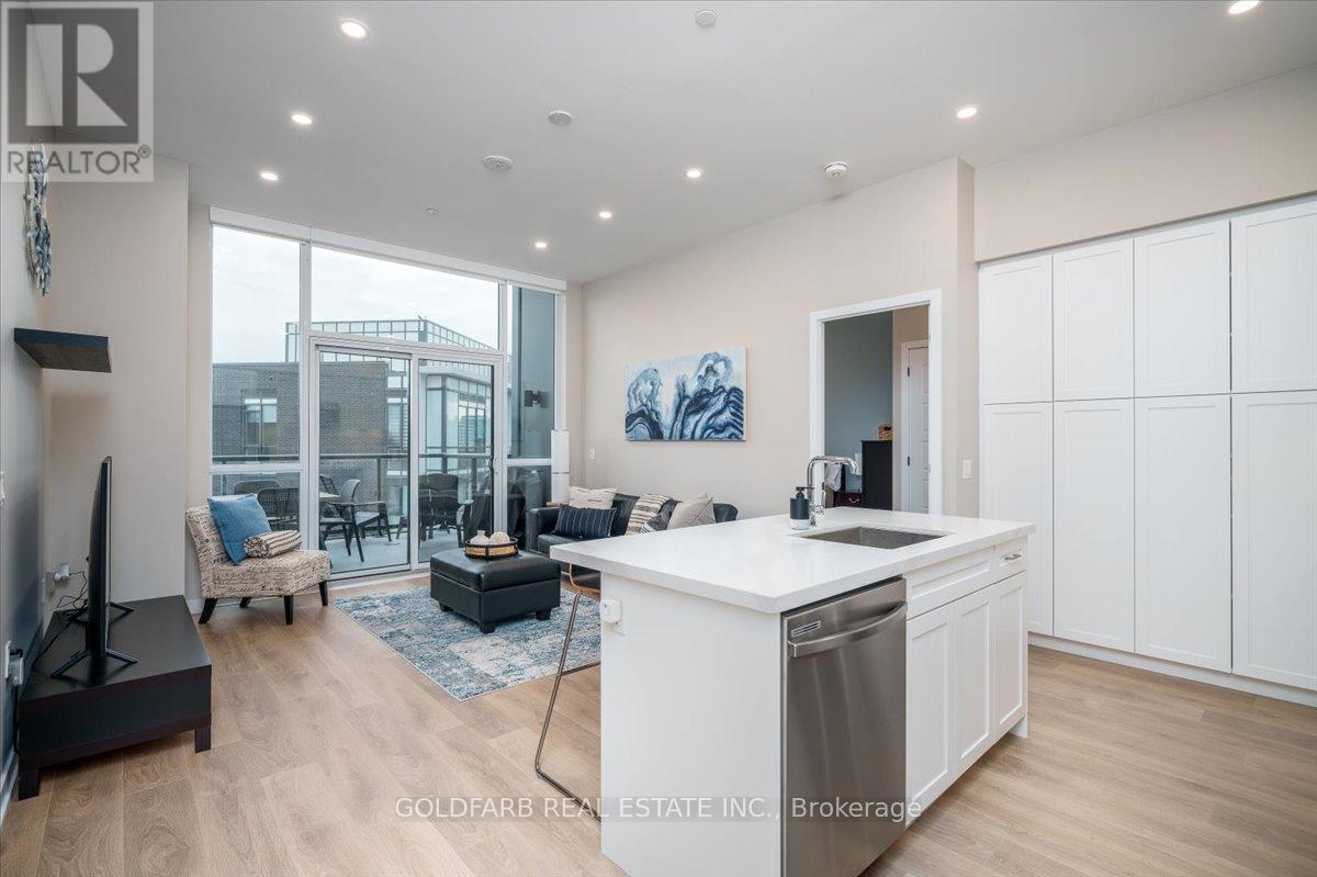 A modern kitchen with white cabinets and a large island.