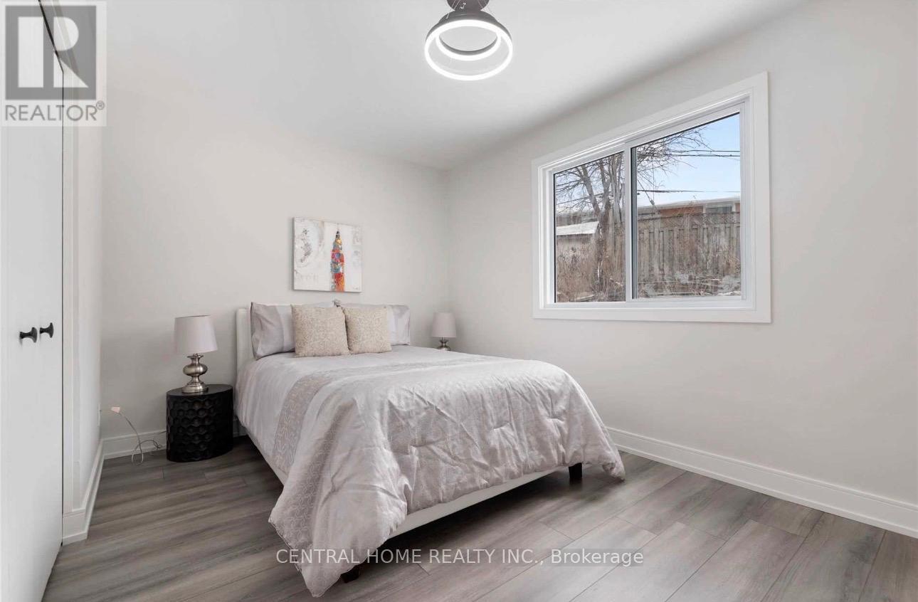 A bedroom with a large bed and a painting on the wall.
