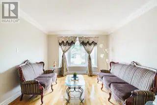 A living room with a sofa set and a glass coffee table.