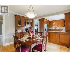 A dining room with a wooden table set for two.