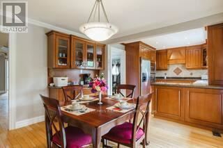 A dining room with a wooden table set for two.