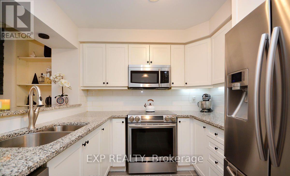 A kitchen with white cabinets and stainless steel appliances.