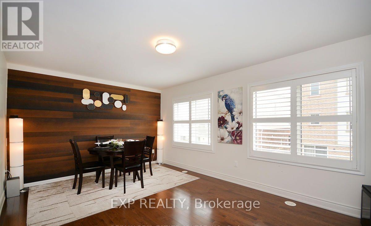A dining room with a wooden table and chairs.