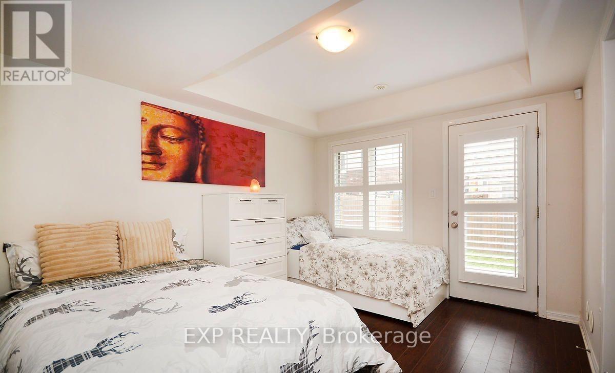 A bedroom with a bed, a dresser, and a painting on the wall.