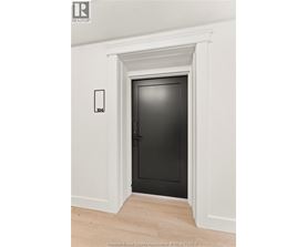 A black door is in a white framed opening.