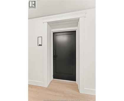 A black door is in a white framed opening.