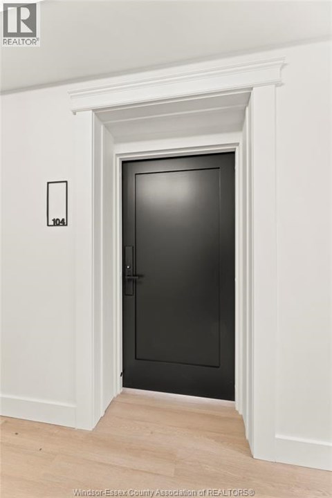 A black door is in a white framed opening.