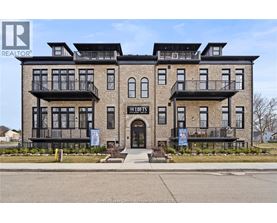 A building with the sign "The Lofts" in front of it.