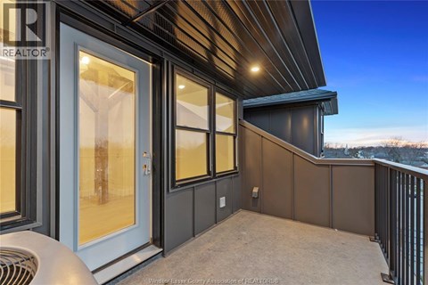 A balcony with a railing and a sliding glass door.
