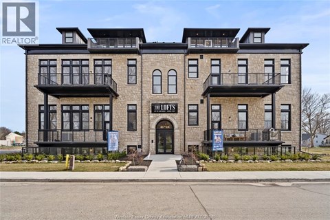 A building with the sign "The Lofts" in front of it.
